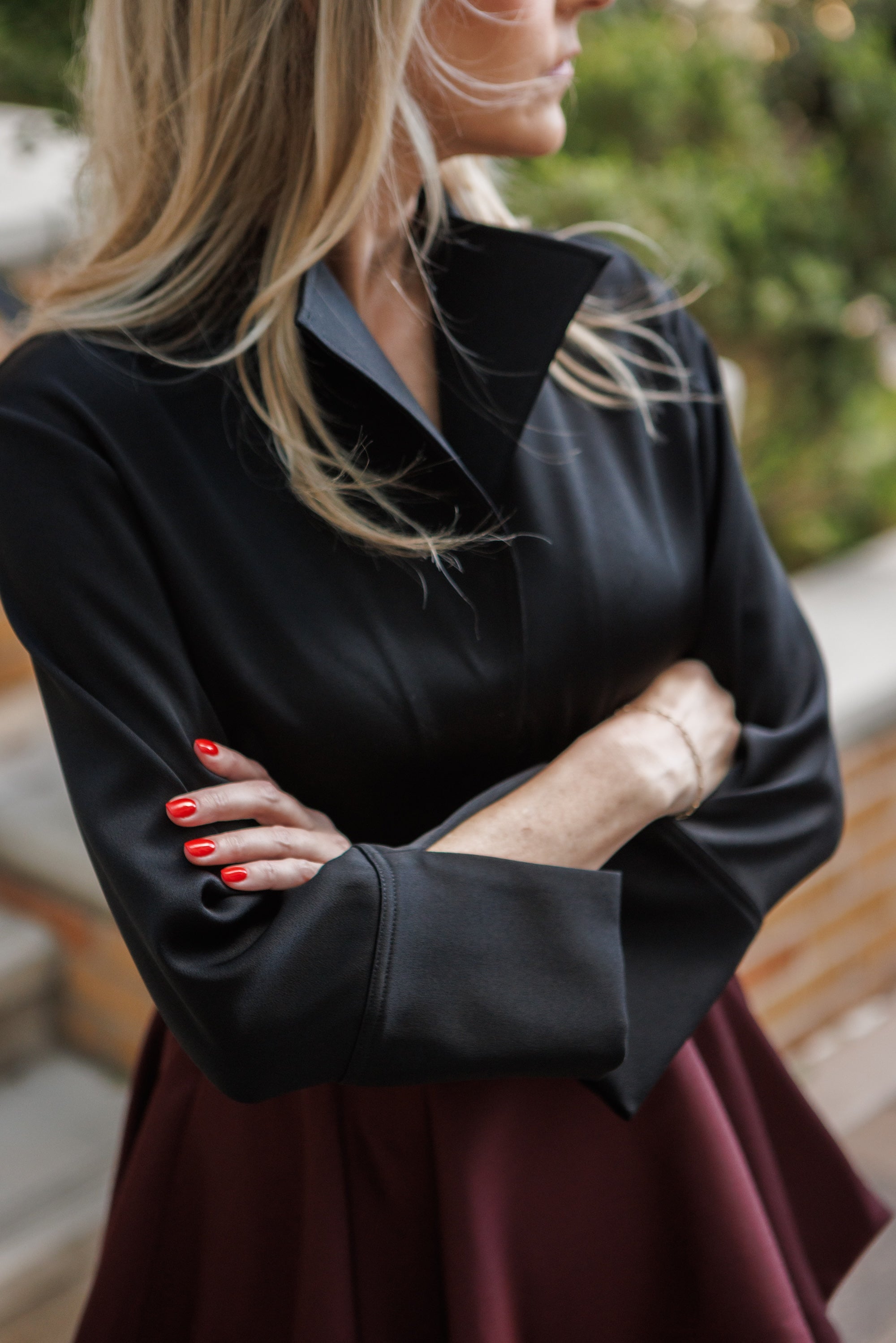 ' Woman wearing a black blouse with structure collar "