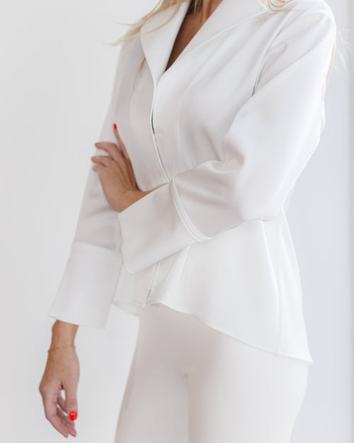 " Woman wearing a white blouse with signature structured collar "